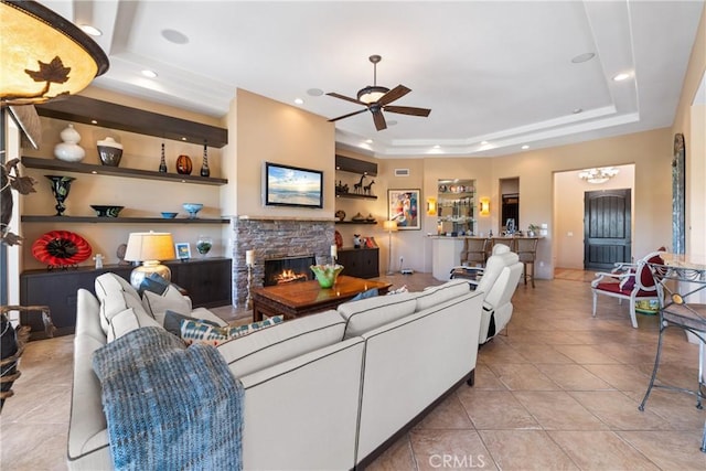 9 Via Haciendas, Rancho Mirage, CA 92270 - living room with a fireplace, a tray ceiling, a ceiling fan, tile patterned flooring, and recessed lighting