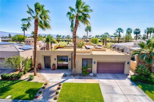 9 Via Haciendas, Rancho Mirage, CA 92270 - view of front of house with concrete driveway, a residential view, a garage, and stucco siding