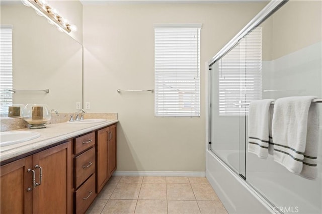 28476 Herrera St, Valencia, CA 91354 - bathroom with baseboards, double vanity, tile patterned flooring, and shower / bath combination with glass door