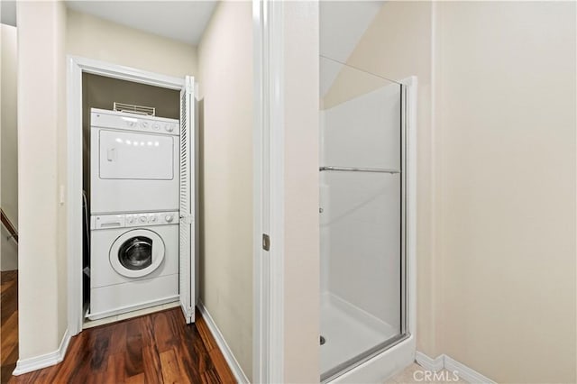 28476 Herrera St, Valencia, CA 91354 - laundry area featuring stacked washer / dryer, dark wood-style floors, and baseboards