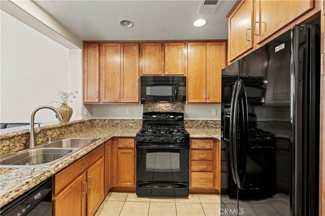 28476 Herrera St, Valencia, CA 91354 - kitchen with black appliances, a sink, brown cabinets, and light tile patterned flooring