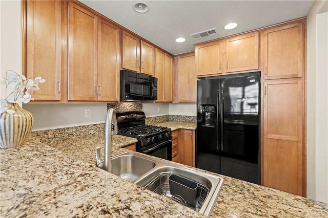 28476 Herrera St, Valencia, CA 91354 - kitchen featuring black appliances, recessed lighting, and light stone countertops