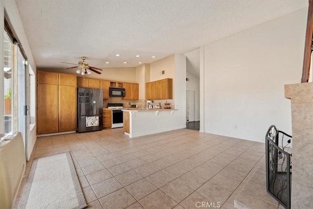 12963 Birch Glen Ct, Victorville, CA 92392 - kitchen featuring black appliances, light tile patterned floors, light countertops, decorative backsplash, and a textured ceiling