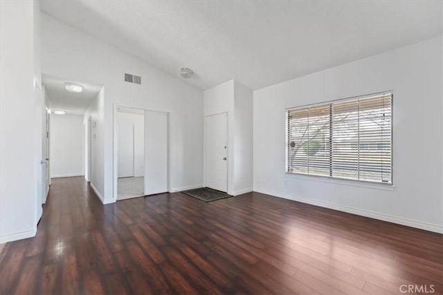 12963 Birch Glen Ct, Victorville, CA 92392 - empty room featuring vaulted ceiling, wood finished floors, and baseboards