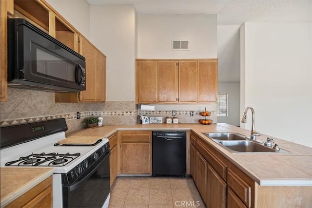 12963 Birch Glen Ct, Victorville, CA 92392 - kitchen featuring black appliances, a peninsula, light countertops, and decorative backsplash