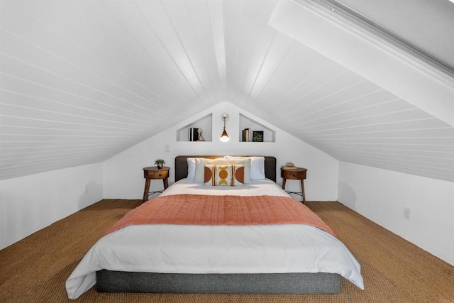 bedroom with carpet floors and lofted ceiling