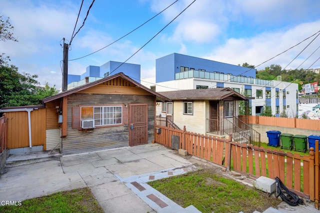 back of property featuring fence and a patio