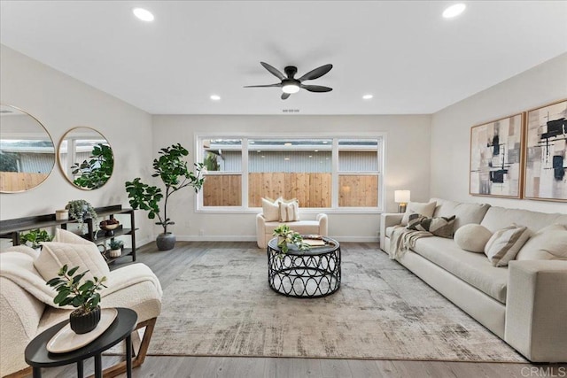 living area featuring wood finished floors, recessed lighting, a ceiling fan, and baseboards