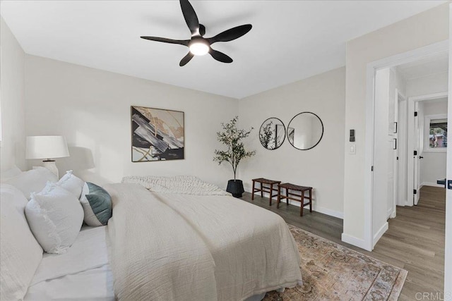 bedroom featuring wood finished floors, ceiling fan, and baseboards