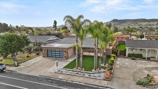 view of front of house with stucco siding, a garage, a residential view, a front yard, and concrete driveway