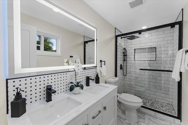 bathroom featuring visible vents, toilet, marble finish floor, and a sink