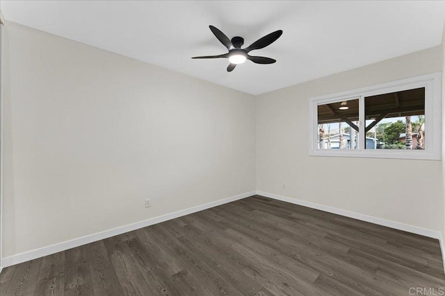 unfurnished room with dark wood-style flooring, ceiling fan, and baseboards
