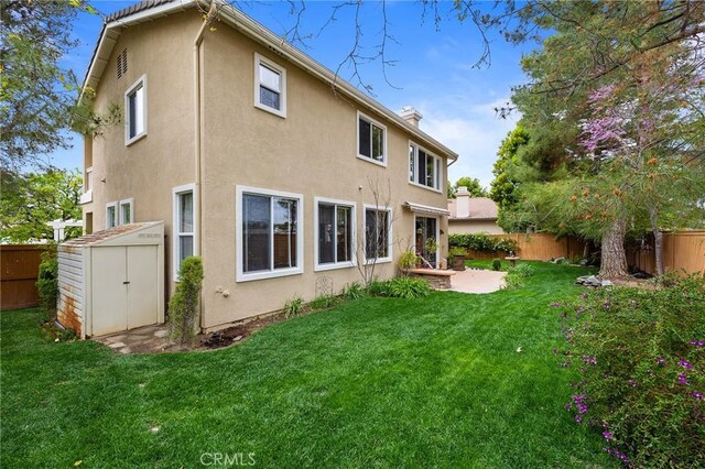 37794 Amber Ln, Murrieta, CA 92562 - rear view of house featuring an outbuilding, a fenced backyard, a lawn, and stucco siding