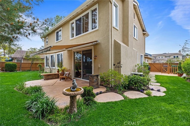 37794 Amber Ln, Murrieta, CA 92562 - back of property featuring stucco siding, a gate, a patio area, fence, and a lawn