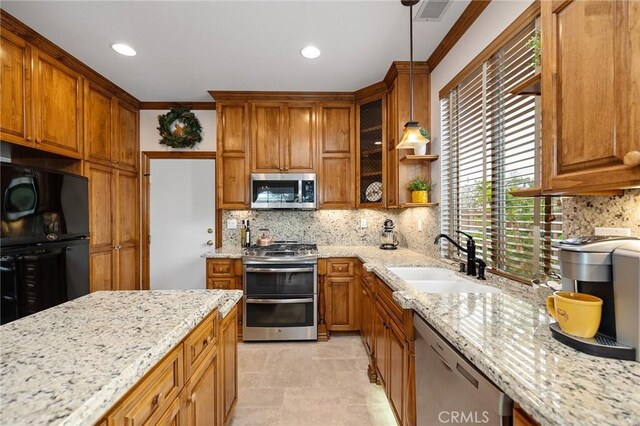 37794 Amber Ln, Murrieta, CA 92562 - kitchen featuring light stone counters, visible vents, brown cabinetry, stainless steel appliances, and a sink