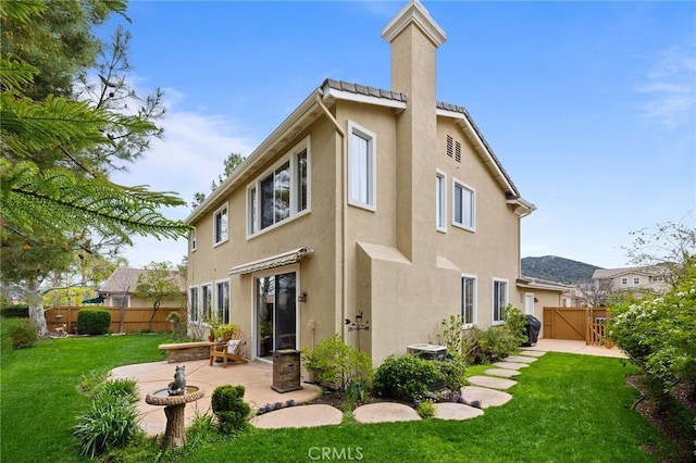 37794 Amber Ln, Murrieta, CA 92562 - back of house with a patio area, stucco siding, fence, and a lawn