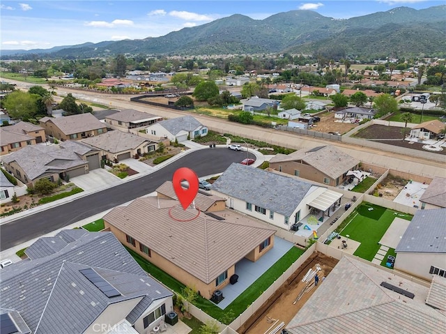 birds eye view of property with a mountain view and a residential view