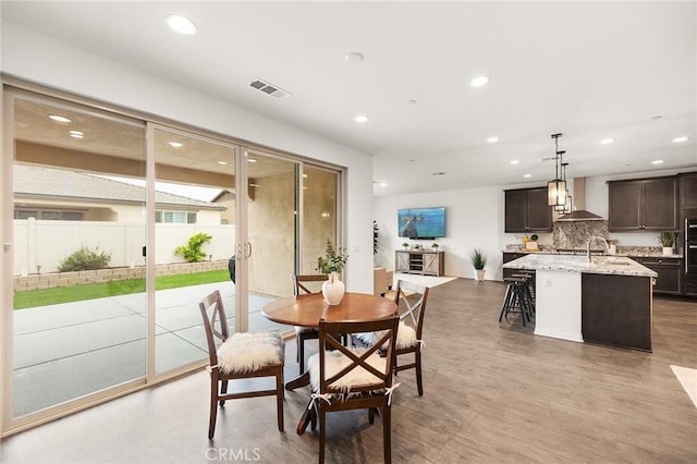 dining room featuring visible vents, recessed lighting, and light wood-style floors