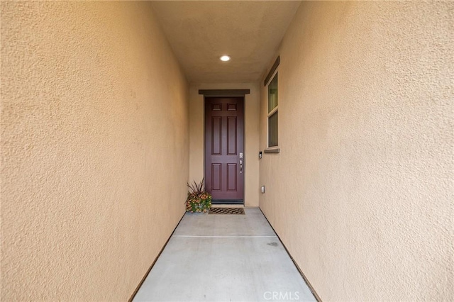 entrance to property featuring stucco siding