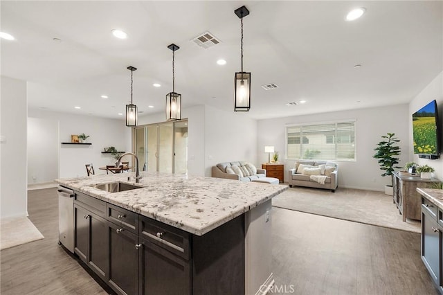 kitchen with recessed lighting, light wood-style floors, visible vents, dishwasher, and a sink