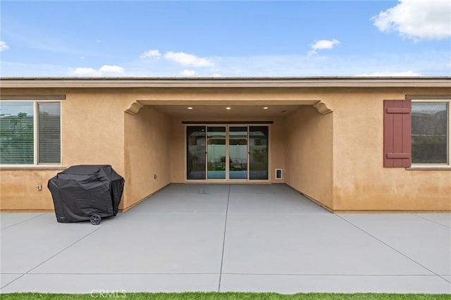 back of house featuring a patio and stucco siding