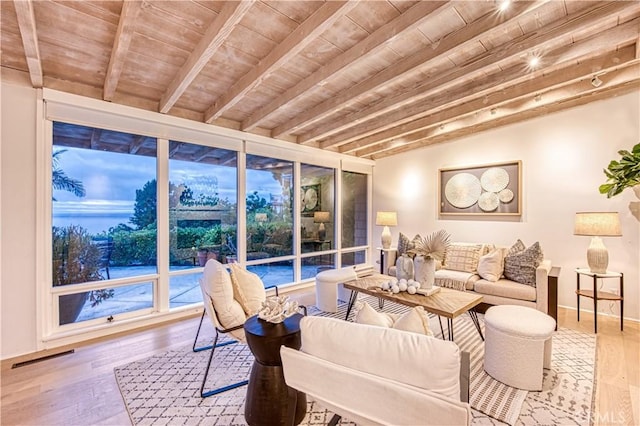 living area with wood ceiling, visible vents, beam ceiling, and wood finished floors