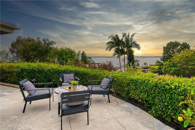 patio terrace at dusk with a water view