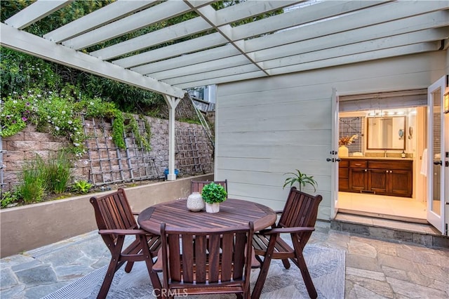 view of patio / terrace featuring a pergola and outdoor dining area
