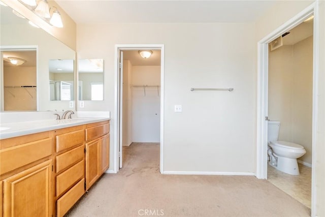 35317 Trevino Trl, Beaumont, CA 92223 - full bathroom featuring toilet, vanity, a walk in closet, and baseboards