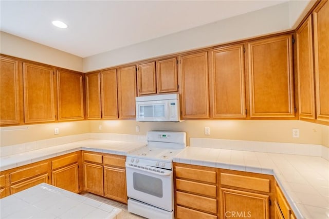 35317 Trevino Trl, Beaumont, CA 92223 - kitchen with light countertops, brown cabinets, and white appliances