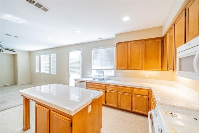 35317 Trevino Trl, Beaumont, CA 92223 - kitchen with white appliances, a sink, tile countertops, visible vents, and light floors