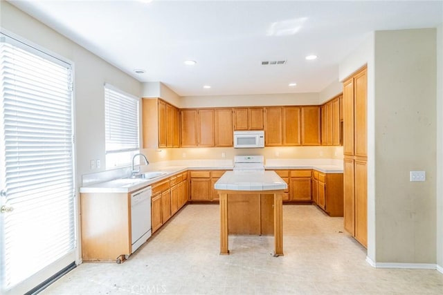 35317 Trevino Trl, Beaumont, CA 92223 - kitchen with visible vents, white appliances, a kitchen island, tile countertops, and a sink
