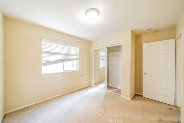 35317 Trevino Trl, Beaumont, CA 92223 - unfurnished bedroom featuring light colored carpet, a closet, and baseboards