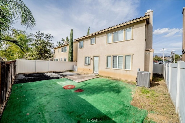 35317 Trevino Trl, Beaumont, CA 92223 - back of house with a fenced backyard, cooling unit, stucco siding, and a yard