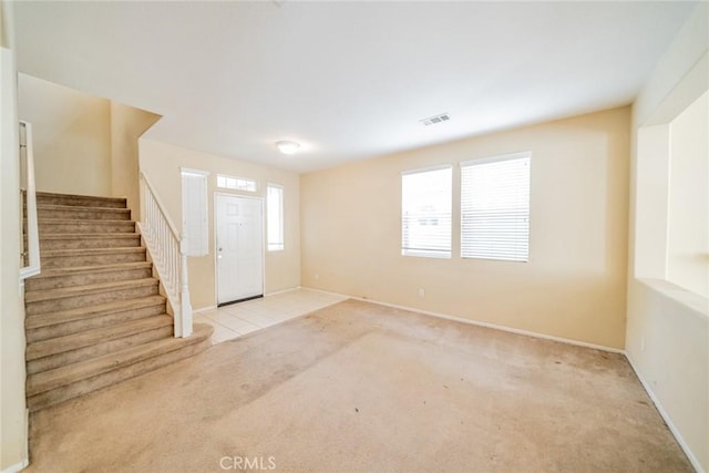 35317 Trevino Trl, Beaumont, CA 92223 - carpeted entryway featuring baseboards, visible vents, and stairway