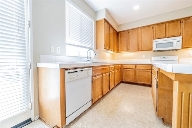 35317 Trevino Trl, Beaumont, CA 92223 - kitchen featuring tile counters, recessed lighting, white appliances, a sink, and light floors