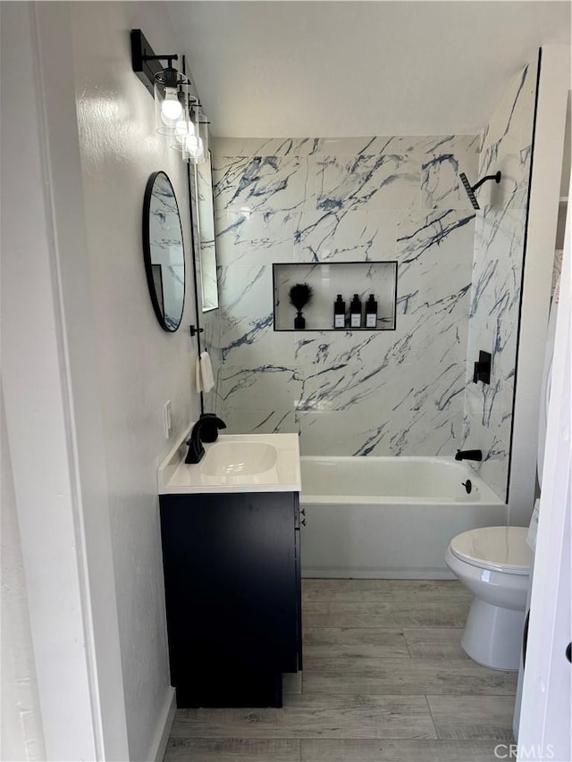 full bath with shower / washtub combination, toilet, vanity, and wood finished floors