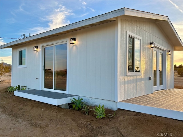 view of side of property with a deck and french doors