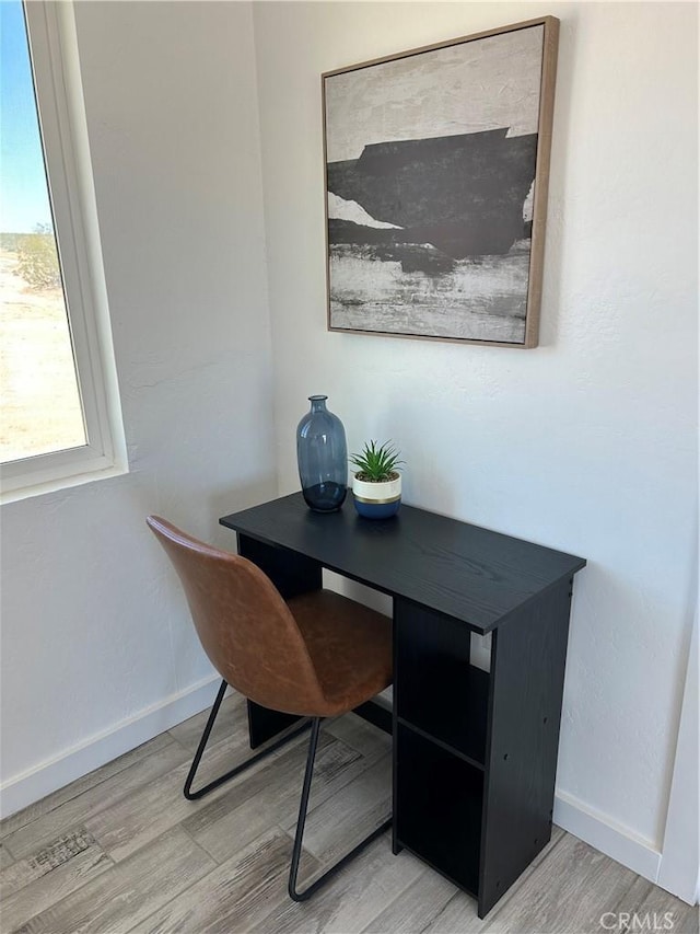 office with baseboards and wood finished floors