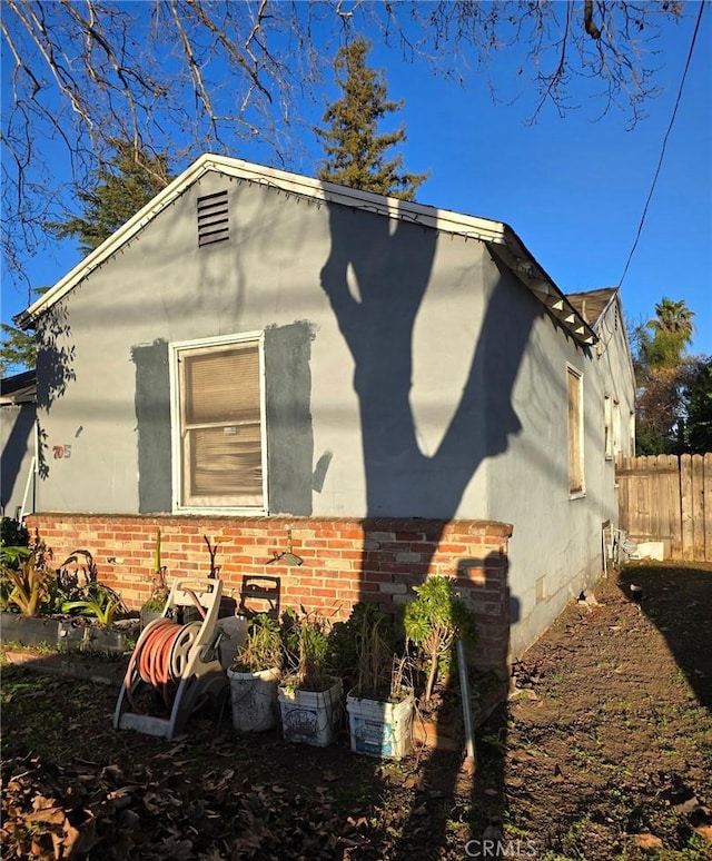 view of property exterior with fence