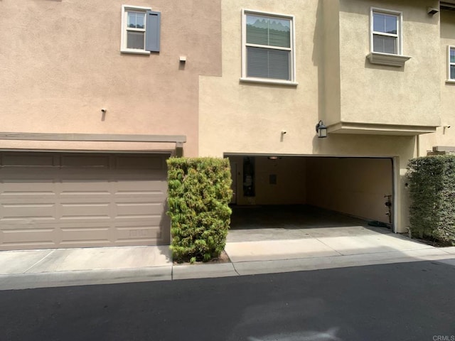 2668 Escala Cir, San Diego, CA 92108 - view of property with an attached garage and stucco siding