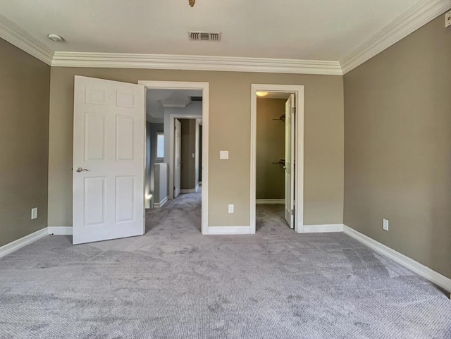 2668 Escala Cir, San Diego, CA 92108 - unfurnished bedroom with visible vents, a walk in closet, baseboards, ornamental molding, and carpet floors