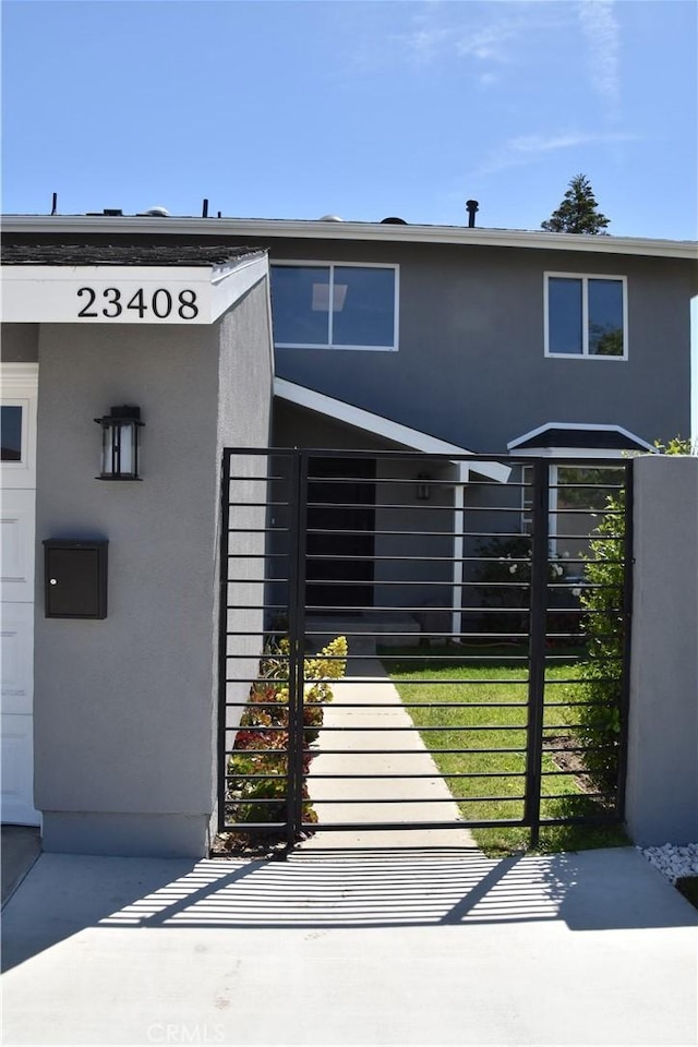 23408 Dorset Pl, Harbor City, CA 90710 - view of property featuring stucco siding, a gate, and fence