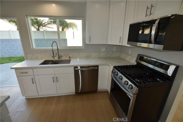23408 Dorset Pl, Harbor City, CA 90710 - kitchen featuring appliances with stainless steel finishes, a sink, and light wood-style floors