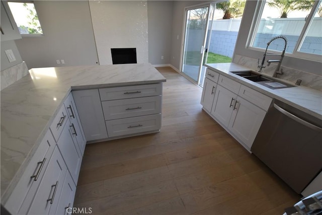 23408 Dorset Pl, Harbor City, CA 90710 - kitchen with white cabinets, a sink, a healthy amount of sunlight, light wood-type flooring, and dishwasher