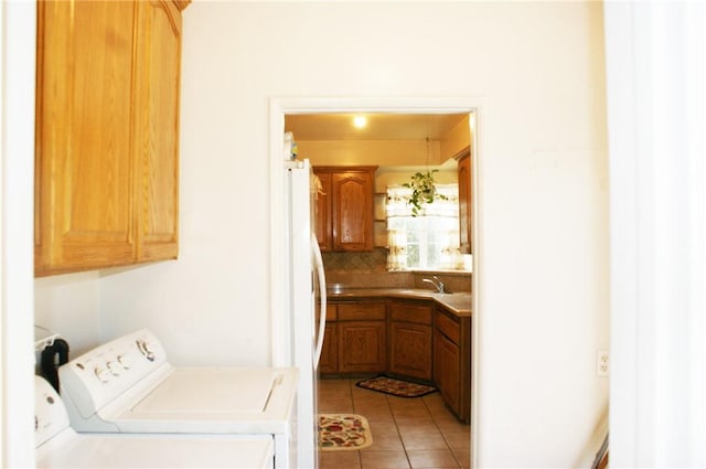 3724 W 105th St, Inglewood, CA 90303 - washroom featuring cabinet space, independent washer and dryer, and light tile patterned flooring
