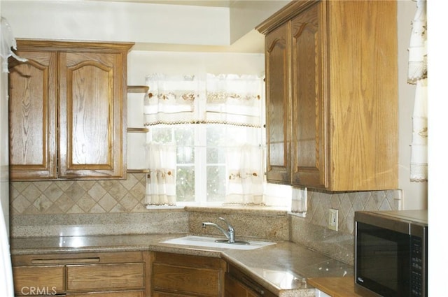 3724 W 105th St, Inglewood, CA 90303 - kitchen featuring decorative backsplash and brown cabinetry