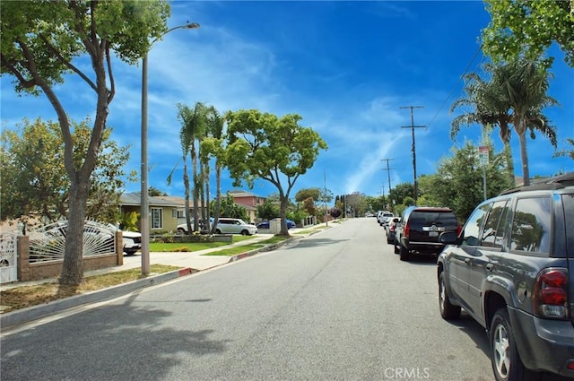 3724 W 105th St, Inglewood, CA 90303 - view of asphalt road featuring sidewalks, street lights, curbs, and a residential view