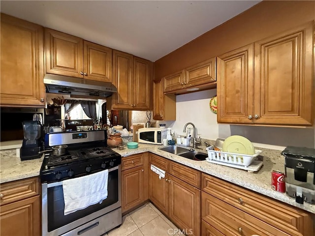 764 W 18th St, Costa Mesa, CA 92627 - kitchen featuring brown cabinetry, gas stove, a sink, white microwave, and under cabinet range hood
