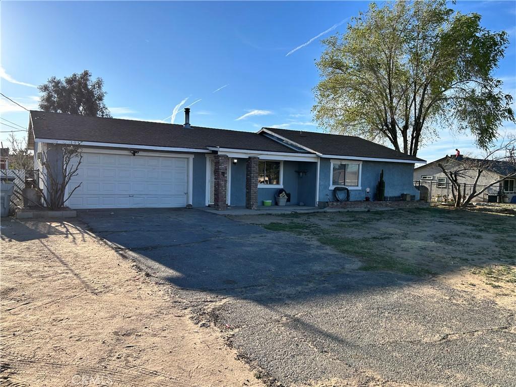 11078 Victor Ave, Hesperia, CA 92345 - ranch-style home featuring aphalt driveway, a garage, and stucco siding